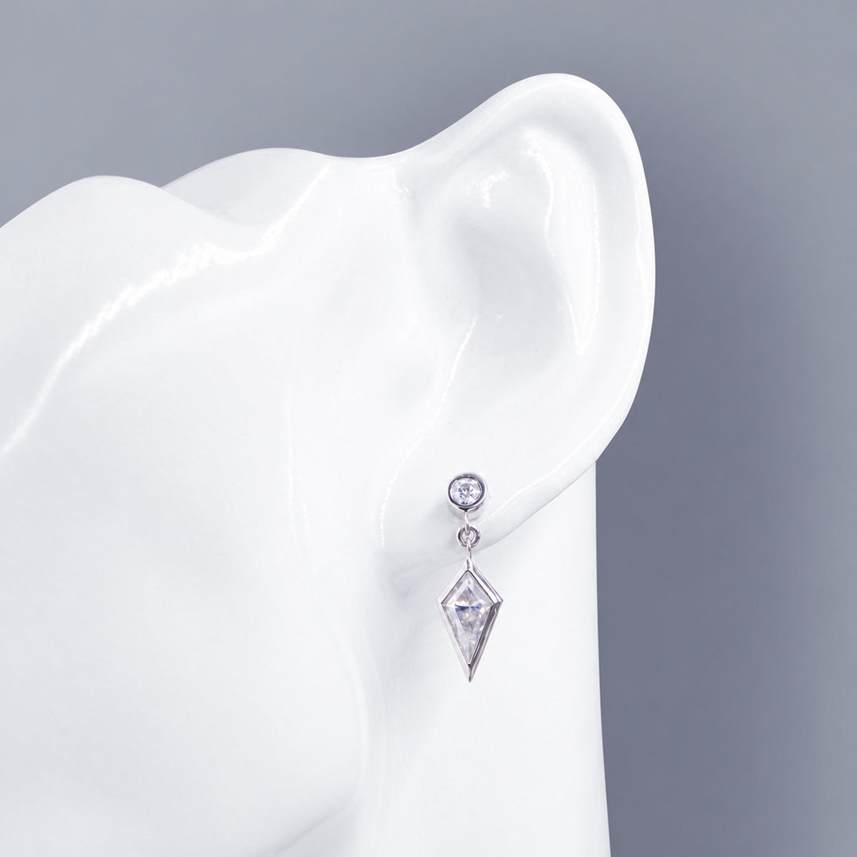 Moissanite drop earring displayed on an ear form