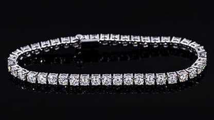 14K white gold moissanite tennis bracelet against black