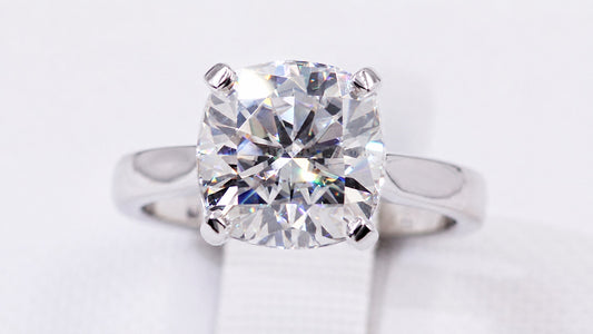 Front view of the cushion-cut moissanite and polished band