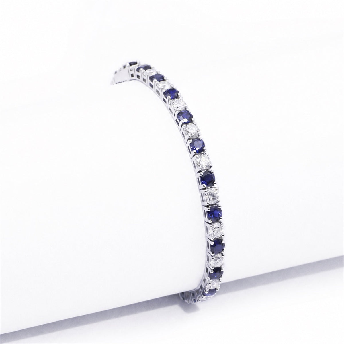Side view of the articulated blue and clear stone bracelet