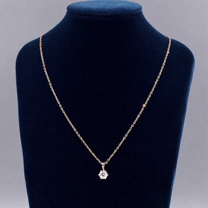 Rose gold moissanite necklace on a black necklace display