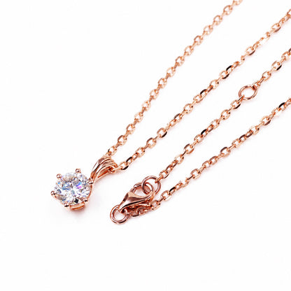 Rose gold solitaire pendant and chain on white
