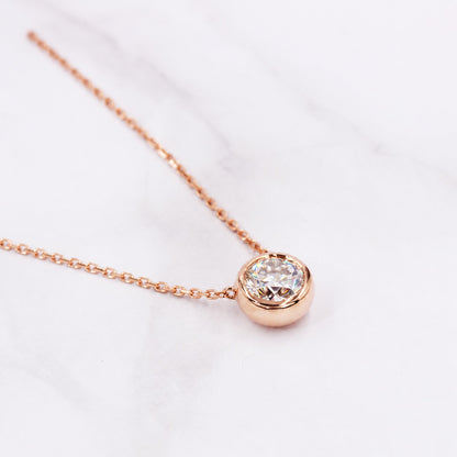 Angled close view of the rose gold bezel moissanite necklace