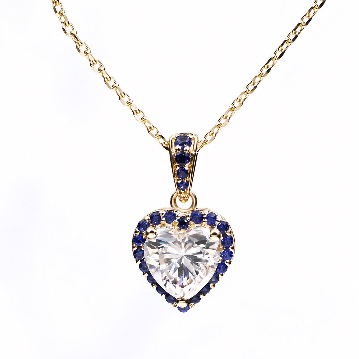 Heart moissanite necklace surrounded by a royal-blue sapphire halo