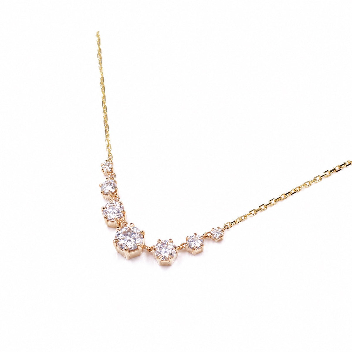 Graduated round moissanite necklace in yellow gold on white