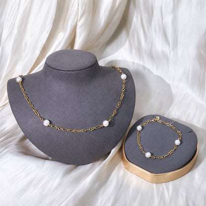 Coordinating pearl necklace and bracelet on display busts