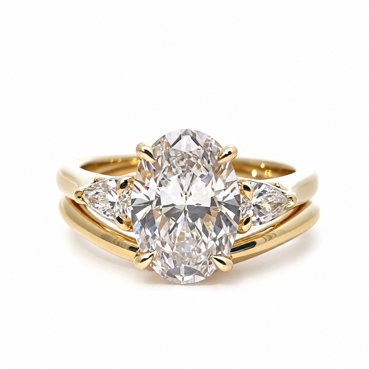 Oval and pear lab diamond bridal ring set in yellow gold