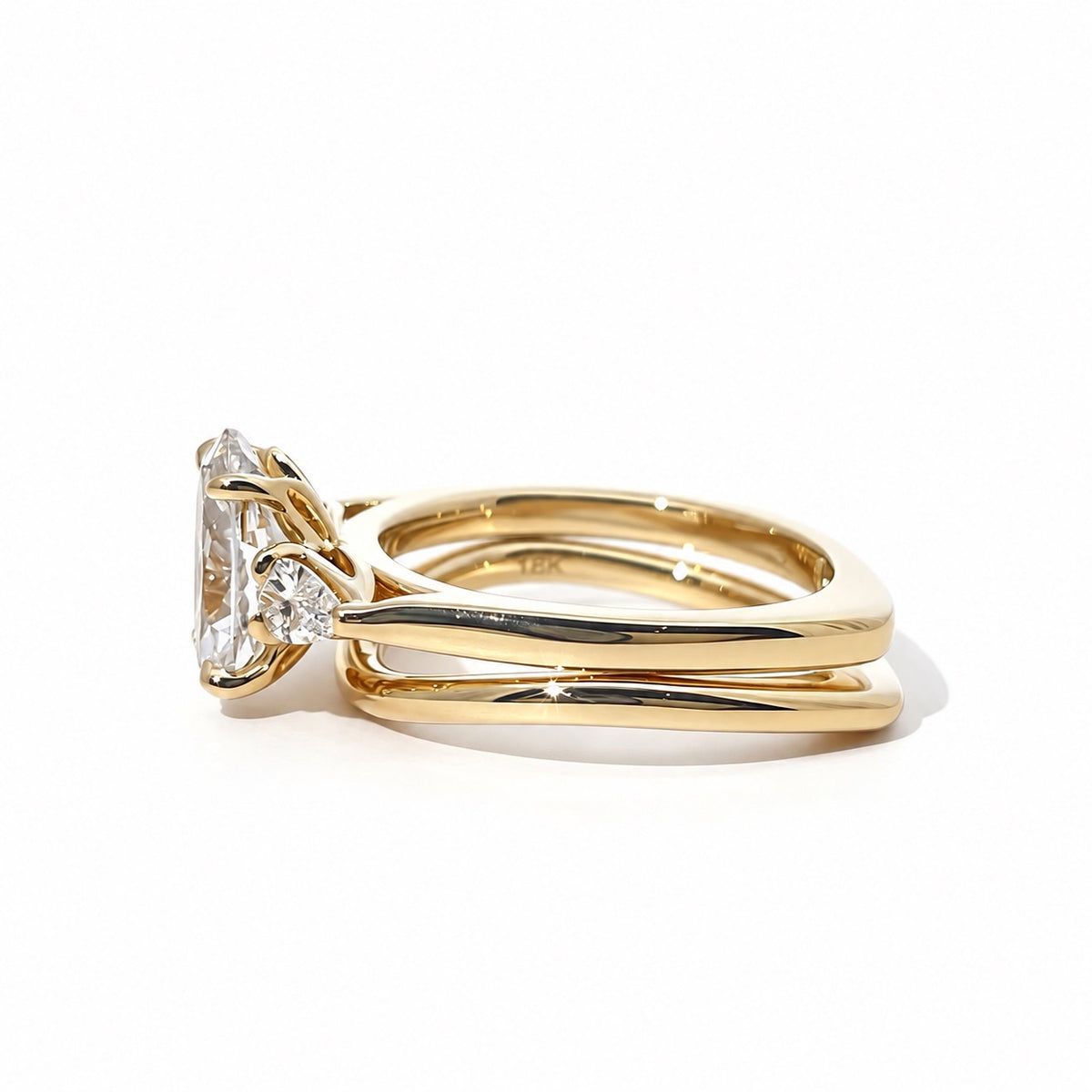 Side view of the three-stone ring and coordinating gold band