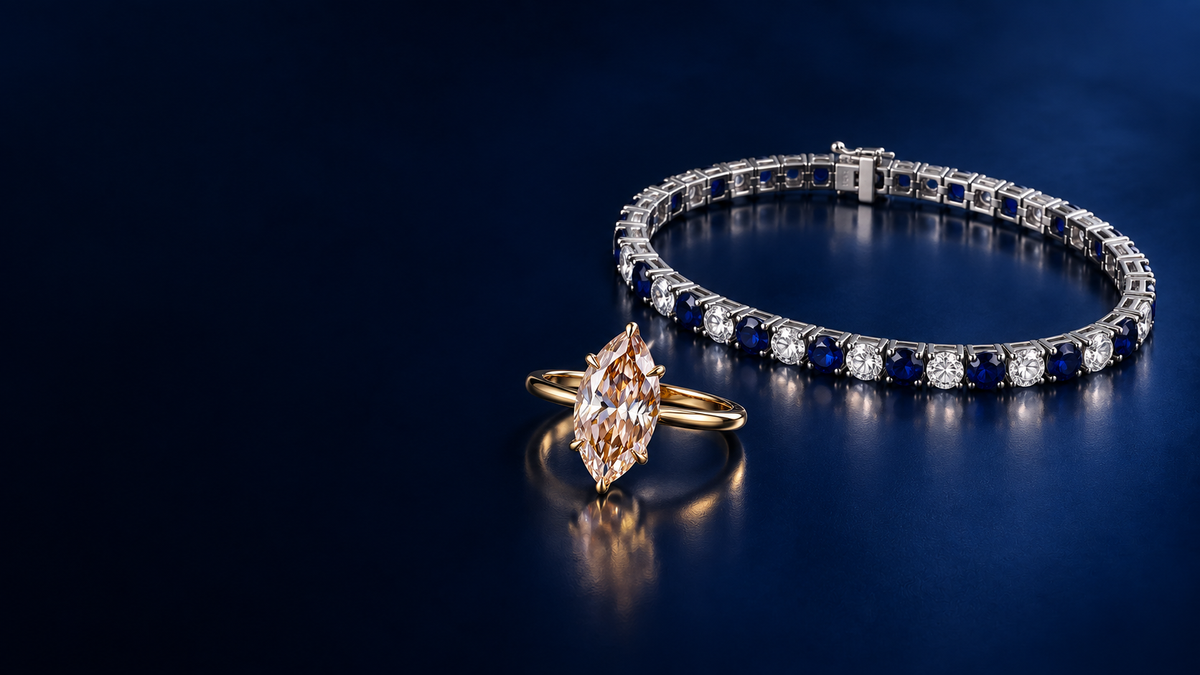 Editorial styling of the champagne marquise ring and blue-and-white tennis bracelet on midnight blue.