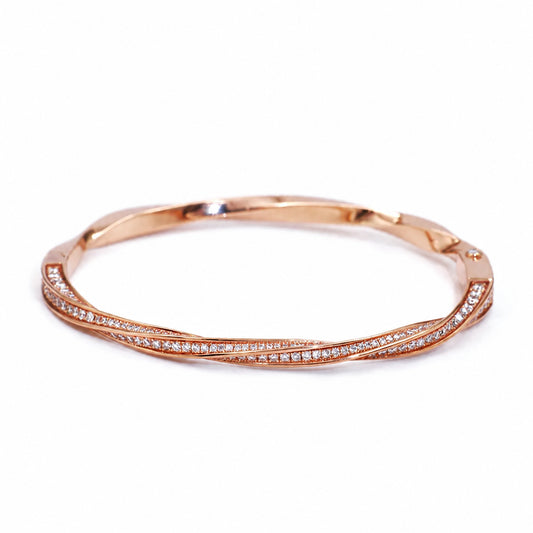 Rose-toned swirl bangle with pavé-set accents